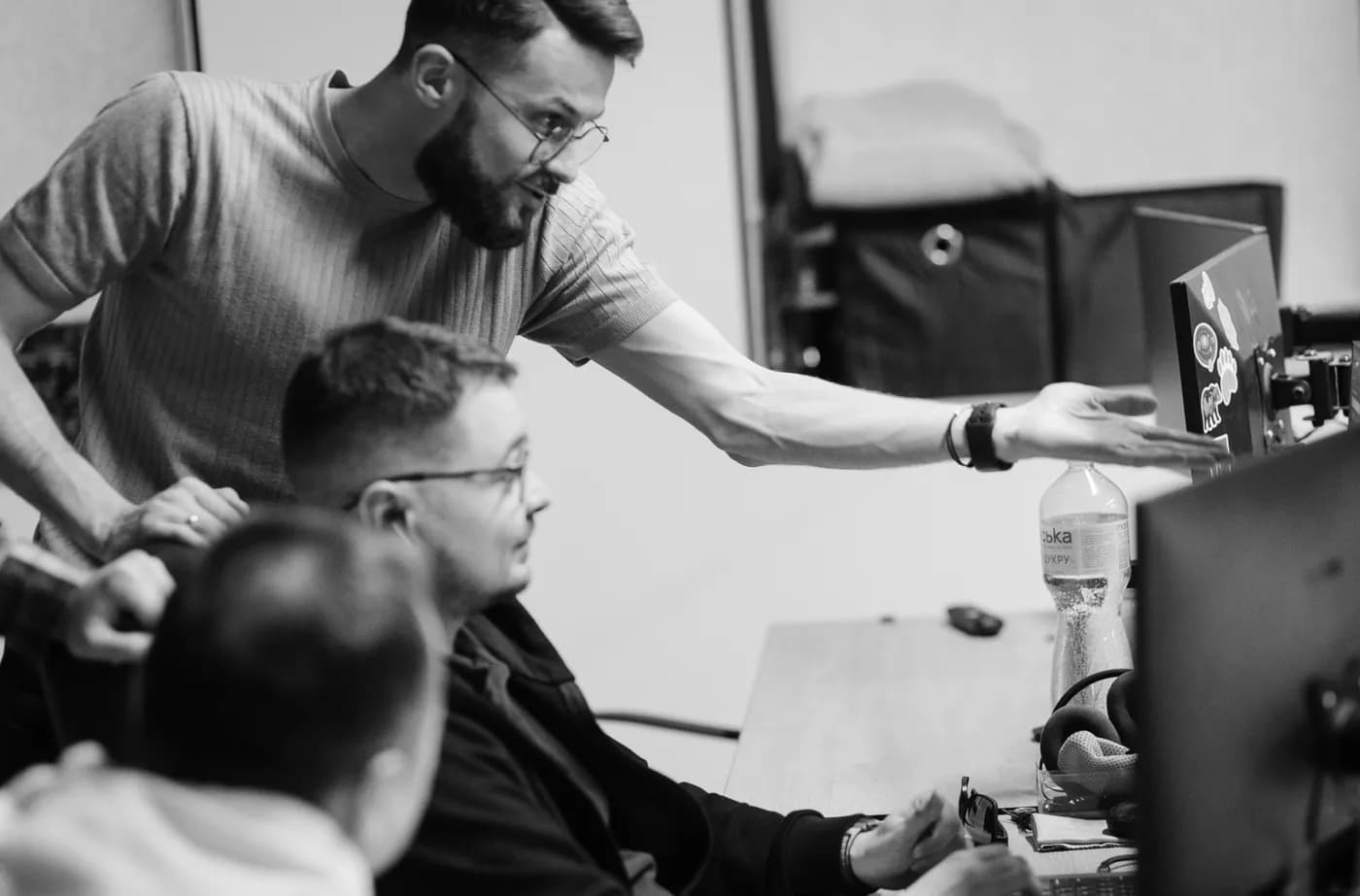 Two developers reviewing a build together at a workstation
