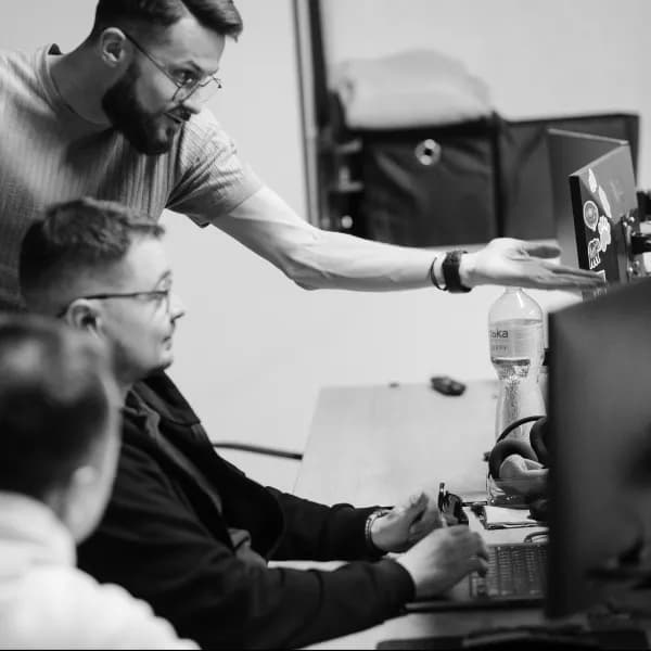 Two developers reviewing a build together at a workstation