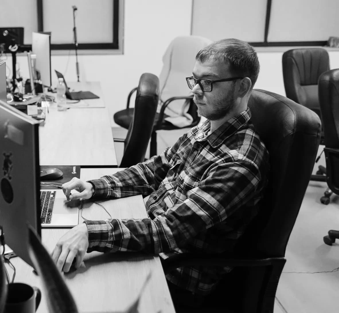 A developer working at a laptop beside a monitor