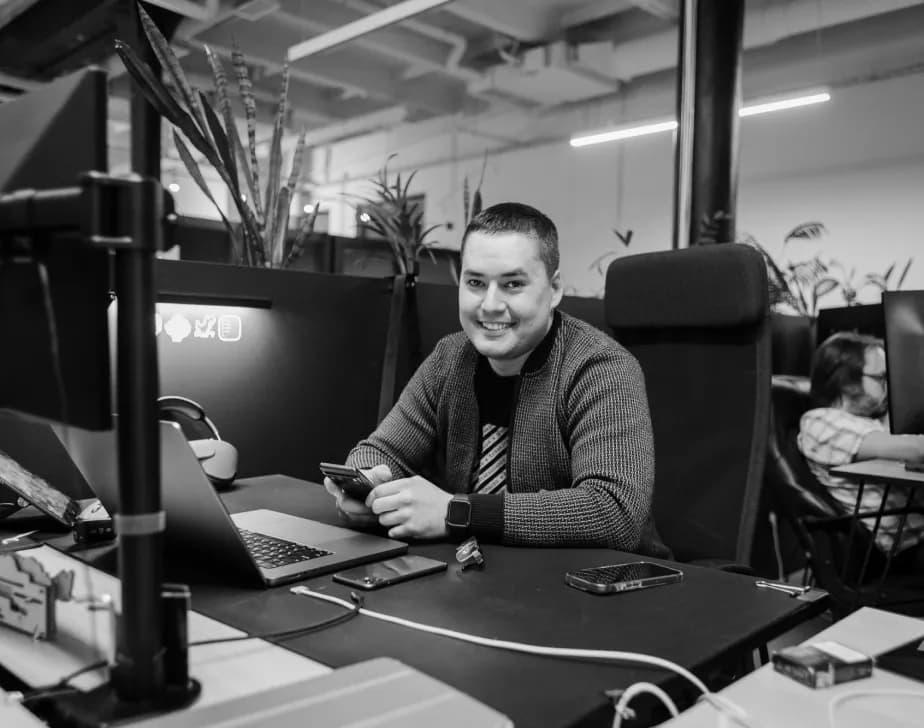 A developer at a desk of monitors in the office