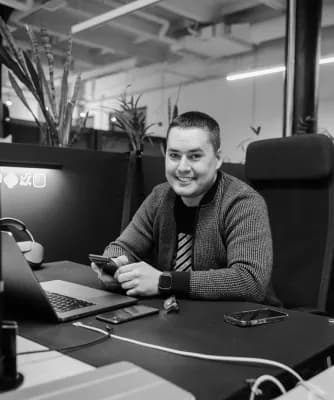 A developer at a desk of monitors in the office