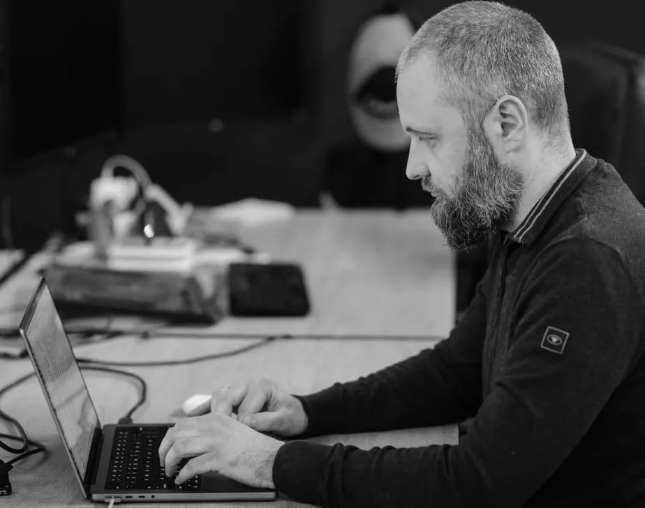A developer working at a laptop in the office