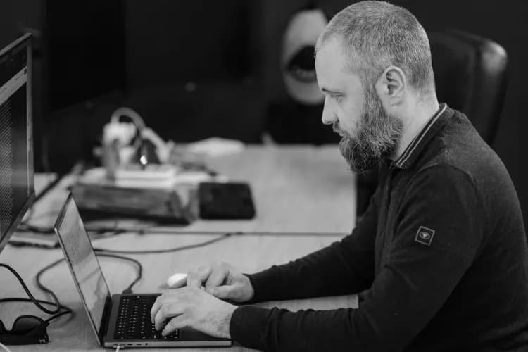 A developer working at a laptop in the office