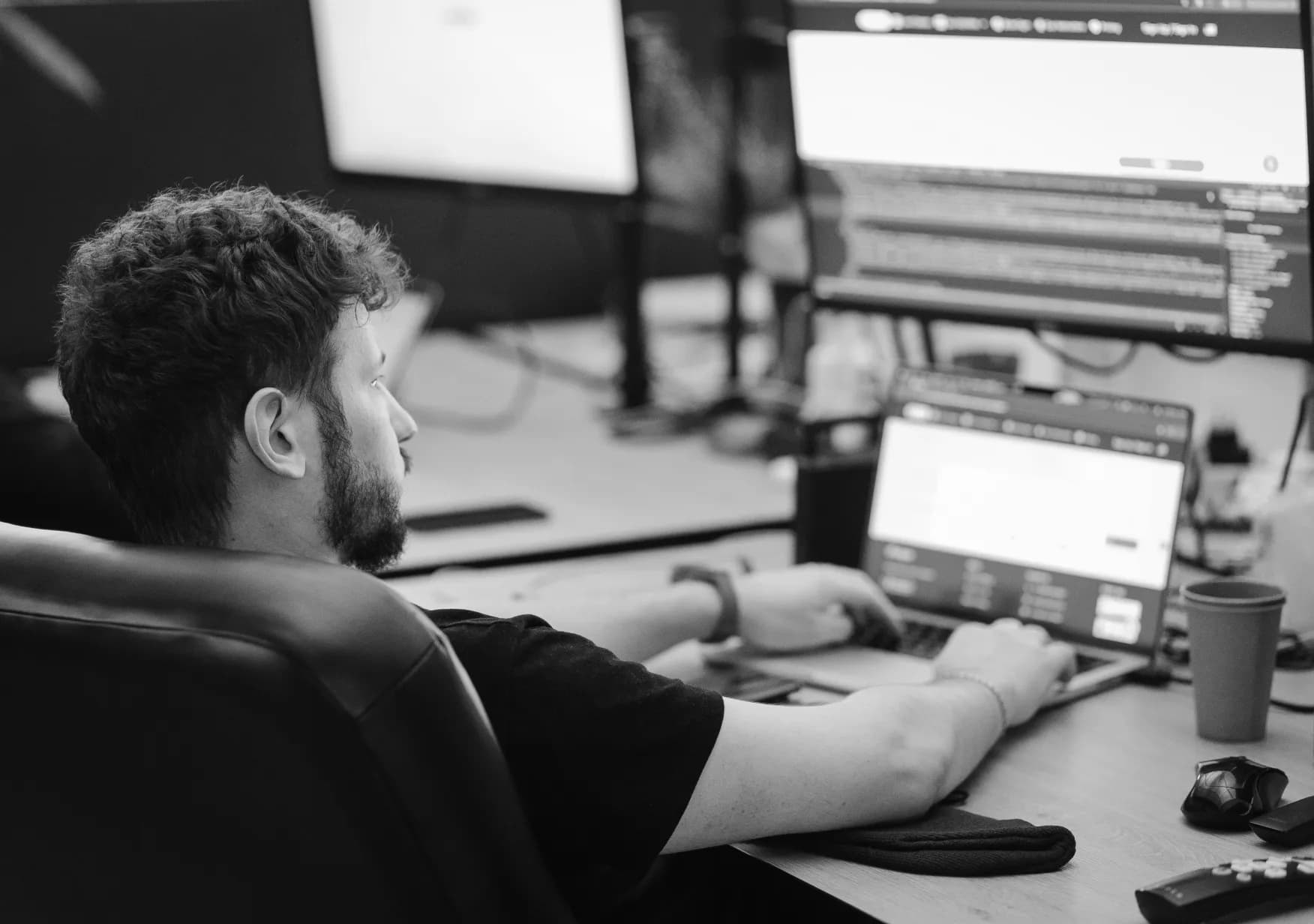 A developer at a multi-monitor workstation