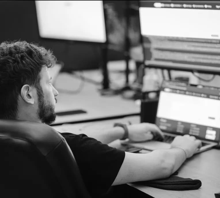 A developer at a multi-monitor workstation