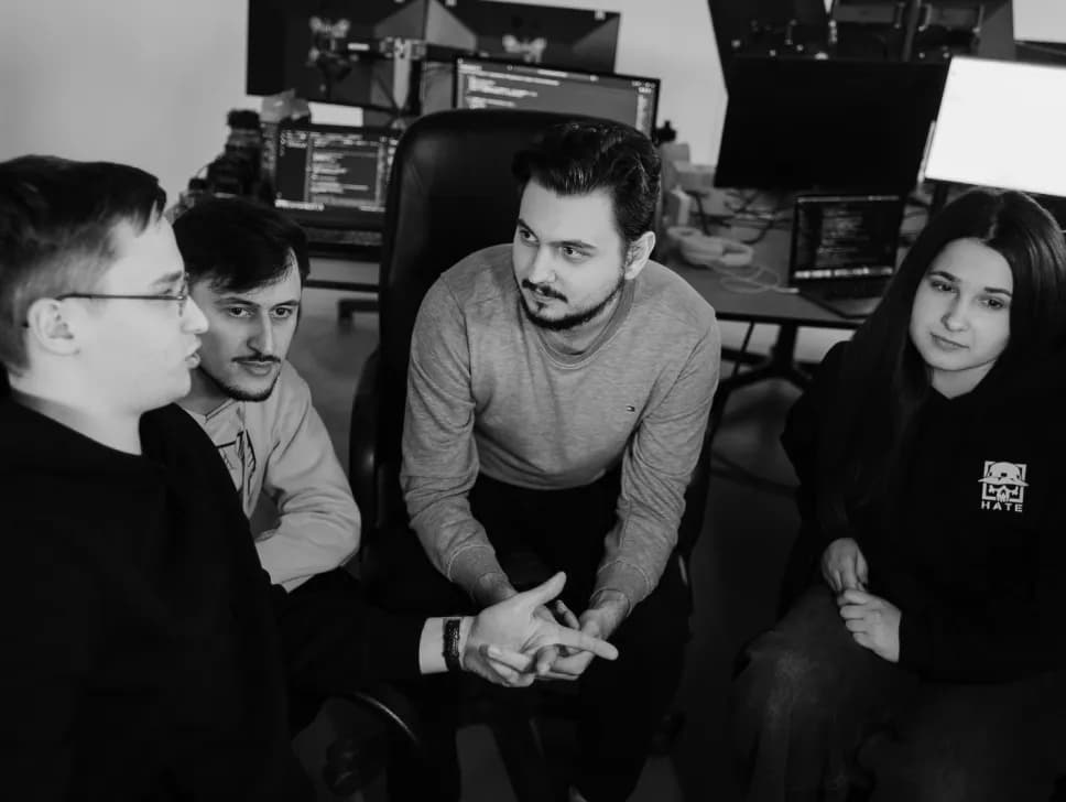 Four team members talking through a task together