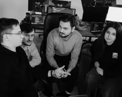 Four team members talking through a task together